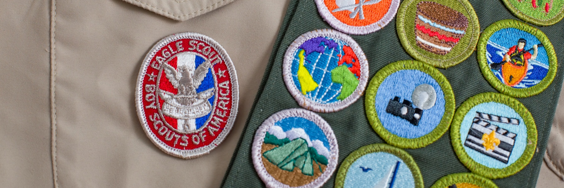 Boy Scout merit badges, including one that says 'Eagle Scout, Boy Scouts of America'