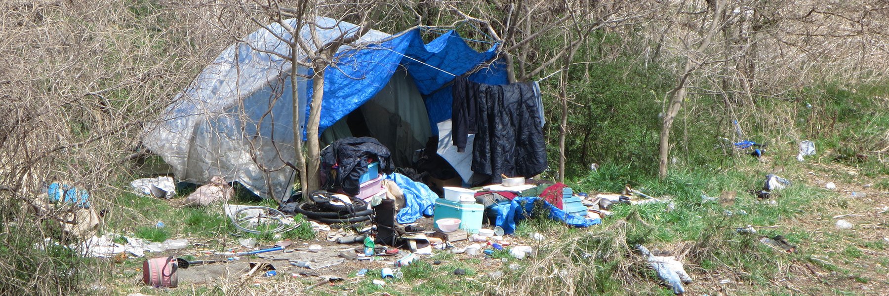 A tent with items strewn around it